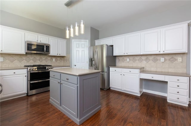 kitchen featuring white cabinetry, stainless steel appliances, and dark wood-style flooring