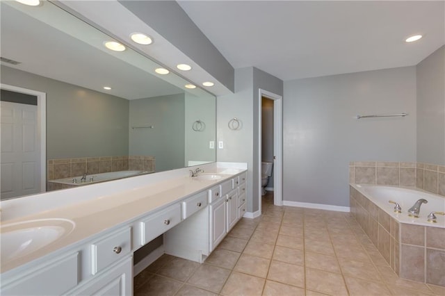 bathroom featuring tile patterned flooring, a sink, toilet, and a bath