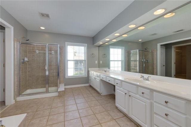 bathroom with a stall shower, visible vents, a sink, and double vanity