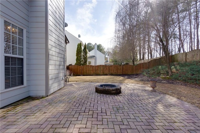 view of patio / terrace with an outdoor fire pit and fence