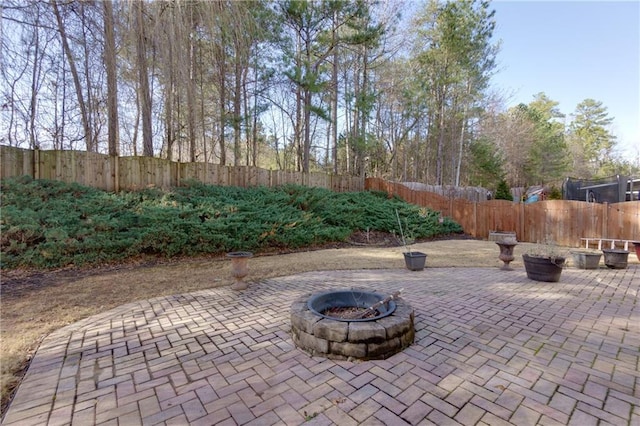 view of patio with an outdoor fire pit and a fenced backyard