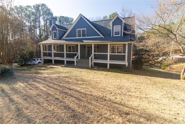 cape cod home featuring a porch and a front yard