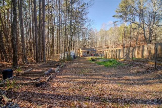 view of yard featuring fence and a view of trees