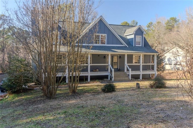 view of front of house with a porch, board and batten siding, and roof with shingles