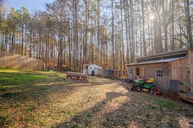 view of yard featuring an outbuilding and fence