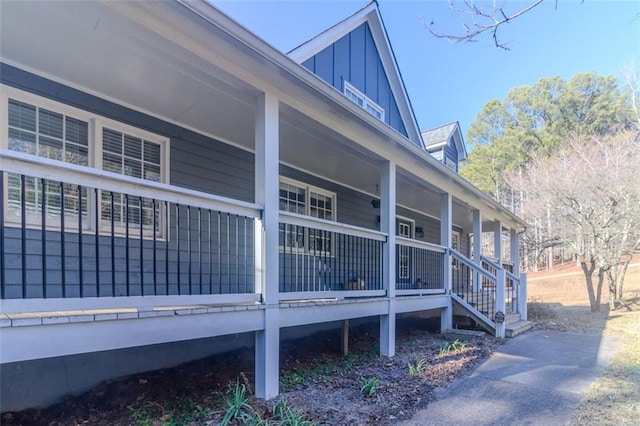 view of property exterior with covered porch and board and batten siding