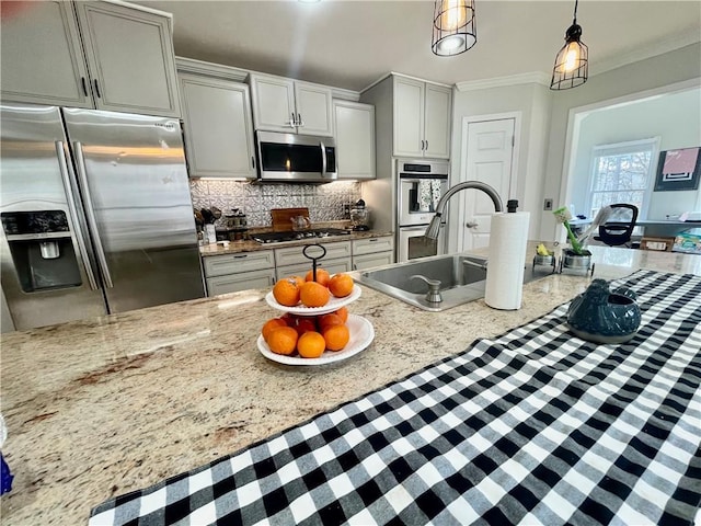 kitchen featuring appliances with stainless steel finishes, crown molding, decorative backsplash, and light stone countertops