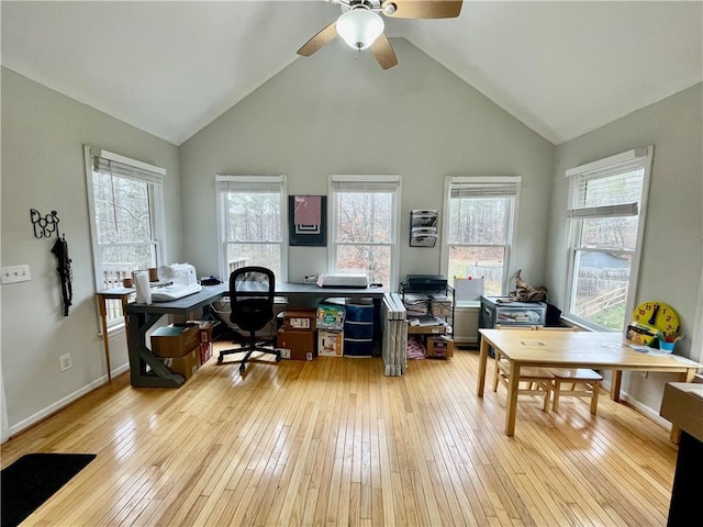 office featuring high vaulted ceiling, baseboards, and hardwood / wood-style floors