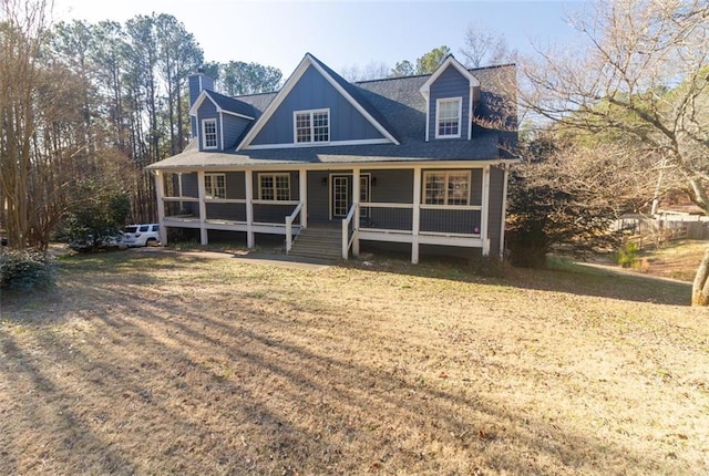 cape cod home with a porch and a front lawn