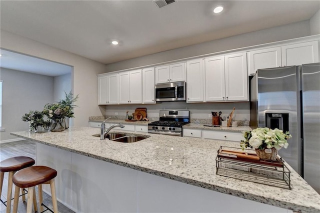 333 Golden Eagle Pkwy, Braselton, GA 30517 - kitchen featuring stainless steel appliances, a sink, white cabinets, and recessed lighting