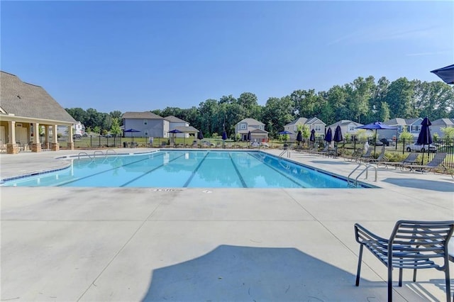 333 Golden Eagle Pkwy, Braselton, GA 30517 - community pool featuring a patio area, view of wooded area, and a residential view