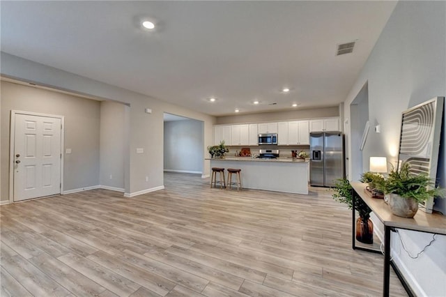 333 Golden Eagle Pkwy, Braselton, GA 30517 - kitchen featuring appliances with stainless steel finishes, light wood finished floors, white cabinets, baseboards, and recessed lighting