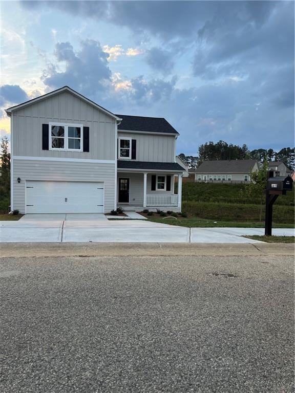 view of front of property featuring a garage and covered porch