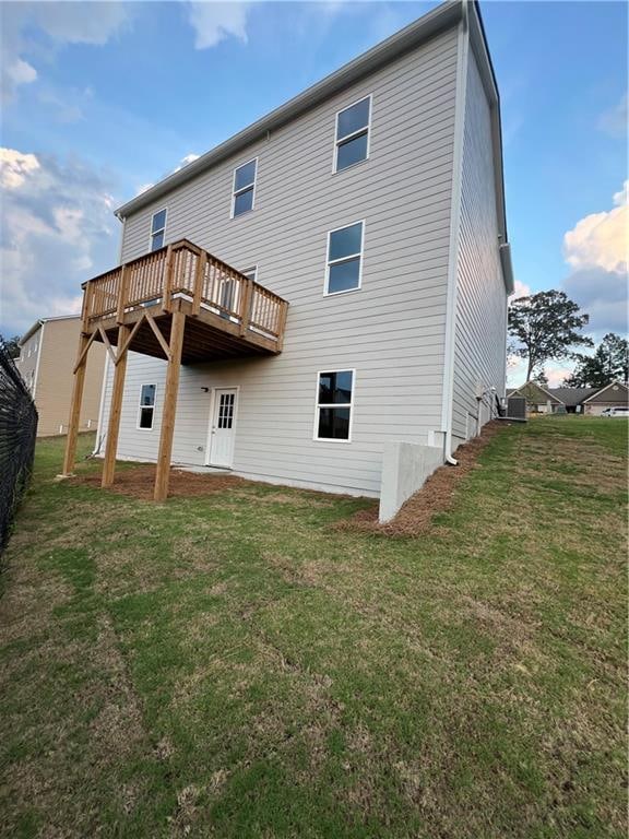 back of house with a yard and a wooden deck