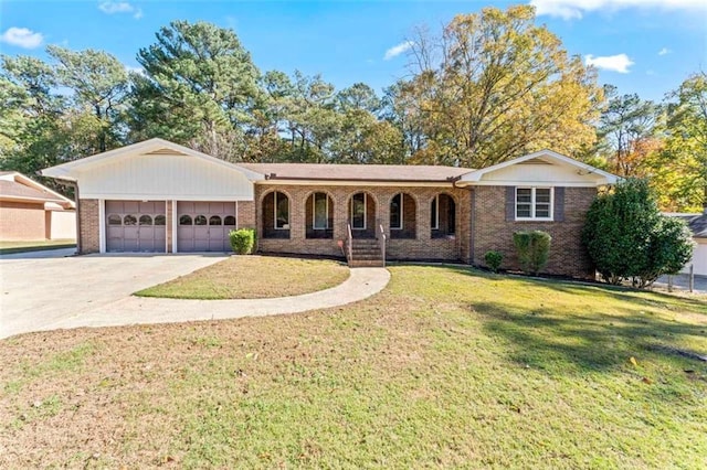 ranch-style house with covered porch, a front yard, and a garage