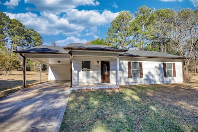 ranch-style home featuring driveway, a front lawn, and an attached carport