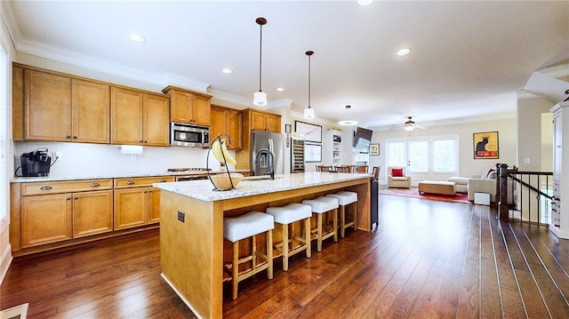 1263 Linden Ct NE, Atlanta, GA 30329 - kitchen with crown molding, dark wood-style flooring, ceiling fan, brown cabinets, and stainless steel appliances