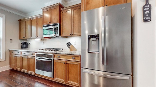 1263 Linden Ct NE, Atlanta, GA 30329 - kitchen with crown molding, appliances with stainless steel finishes, dark wood finished floors, brown cabinetry, and backsplash