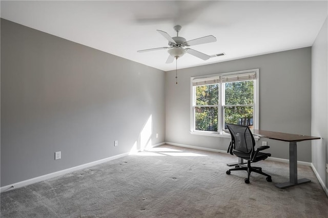 unfurnished office with ceiling fan and carpet floors