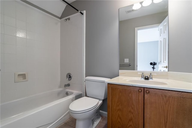 full bathroom featuring tiled shower / bath, tile patterned floors, toilet, and vanity