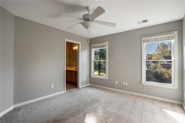 spare room featuring ceiling fan and light colored carpet