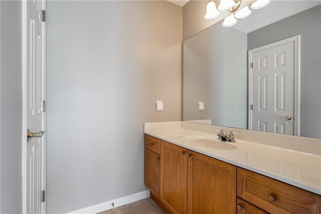 bathroom featuring tile patterned floors, vanity, and a notable chandelier