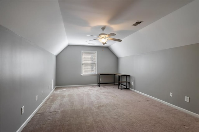 additional living space featuring ceiling fan, light carpet, and vaulted ceiling