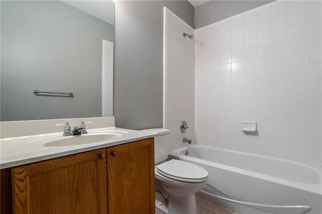 full bathroom featuring vanity, toilet, and tiled shower / bath combo