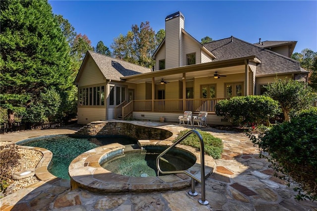 back of house featuring a patio, ceiling fan, and an in ground hot tub