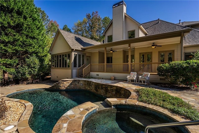 rear view of house featuring ceiling fan, a swimming pool with hot tub, and a patio