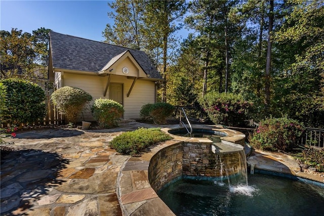 view of patio / terrace featuring an in ground hot tub