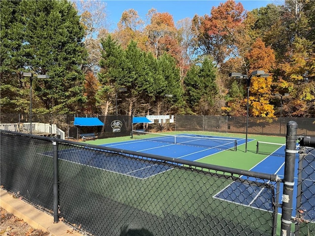 view of tennis court featuring basketball court