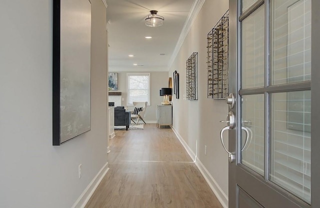 hallway with crown molding and light hardwood / wood-style flooring