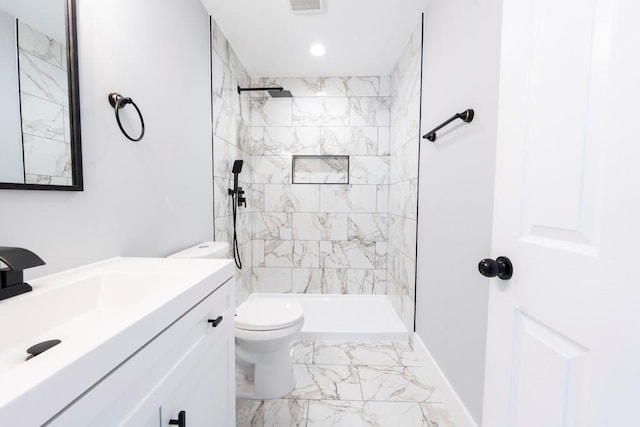 full bathroom featuring vanity, toilet, marble finish floor, and tiled shower