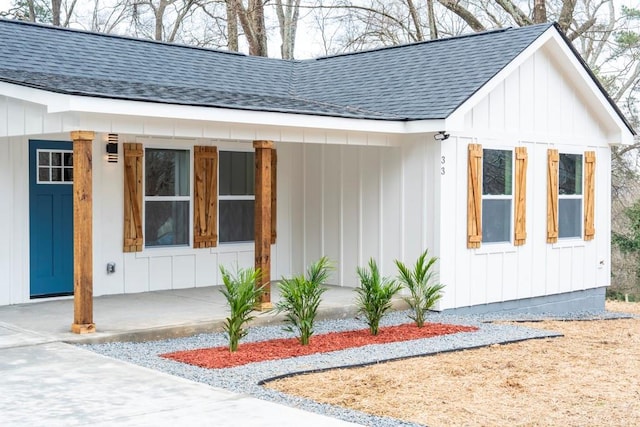 view of front of home featuring covered porch, board and batten siding, and a shingled roof