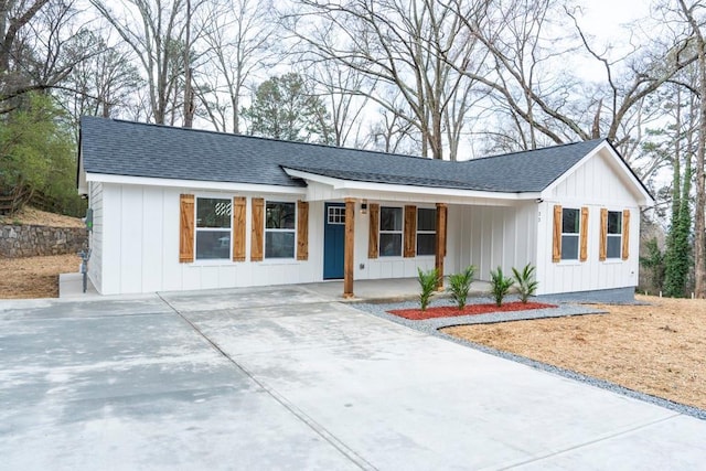 modern inspired farmhouse with a porch, board and batten siding, concrete driveway, and a shingled roof