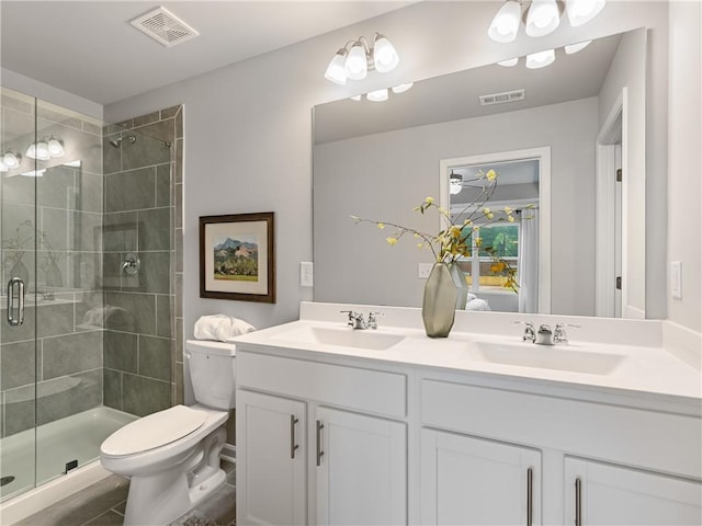 bathroom with walk in shower, tile patterned floors, vanity, and toilet