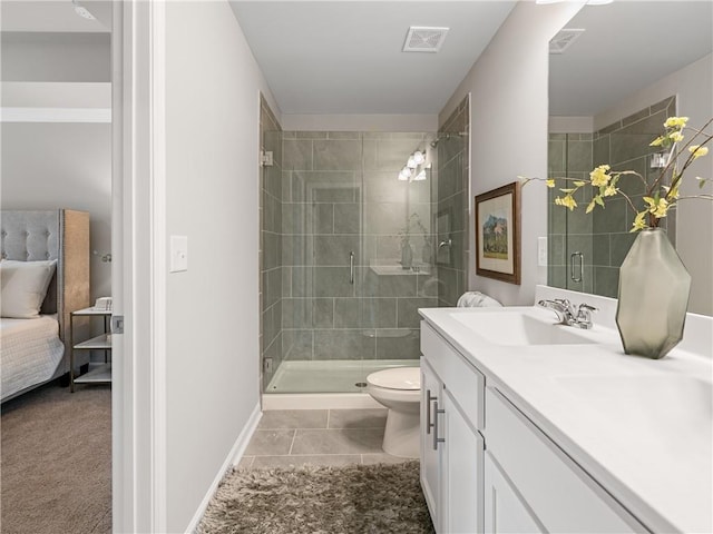 bathroom with toilet, tile patterned flooring, a shower with door, and vanity