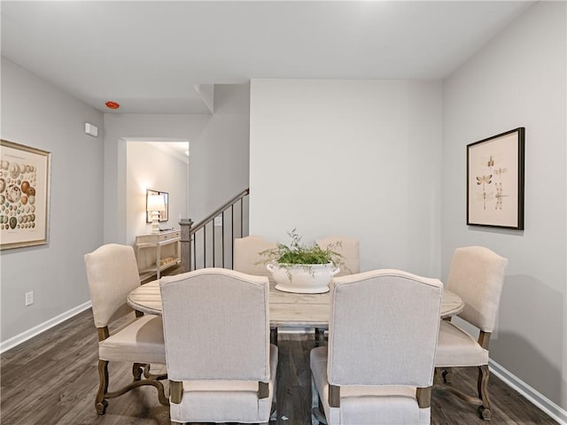 dining space with dark hardwood / wood-style flooring