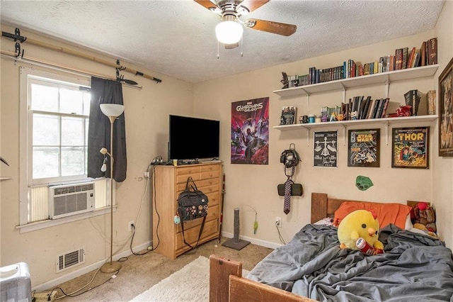 carpeted bedroom featuring ceiling fan, cooling unit, and a textured ceiling