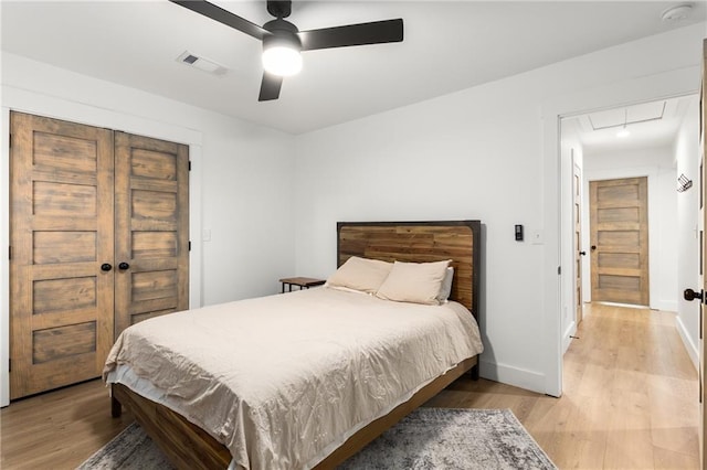 bedroom with light hardwood / wood-style flooring and ceiling fan