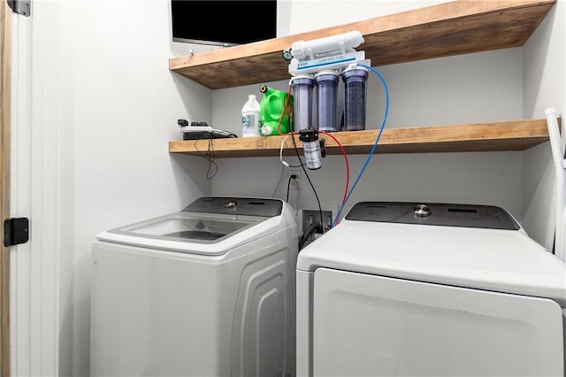 clothes washing area featuring separate washer and dryer