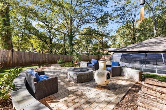 view of patio featuring an outdoor living space with a fire pit