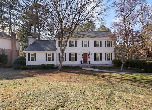 colonial-style house with a front lawn