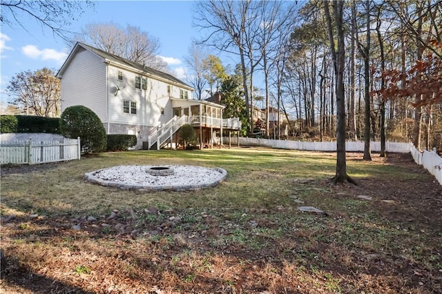 view of yard featuring a fire pit and a deck