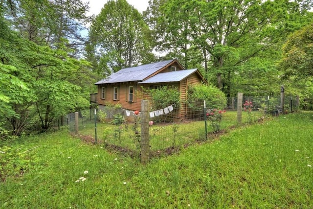 view of side of home with metal roof