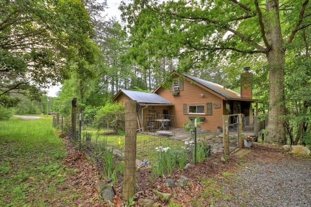 back of property with a chimney