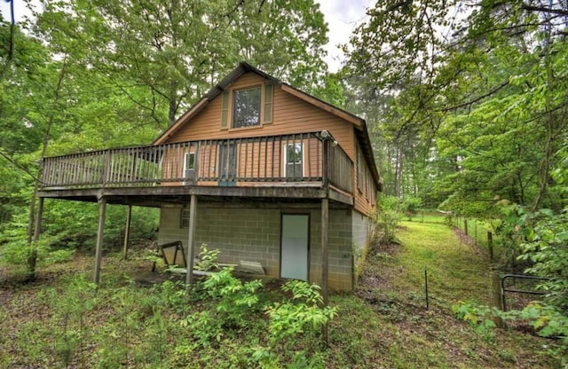 rear view of house featuring a deck