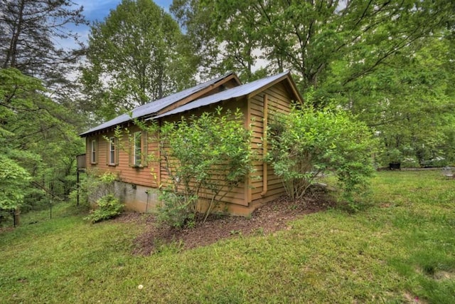 view of side of property with a yard