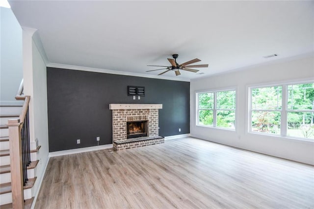 5354 Shadow Walk Way, Gainesville, GA 30507 - unfurnished living room with stairs, crown molding, wood finished floors, a ceiling fan, and a fireplace